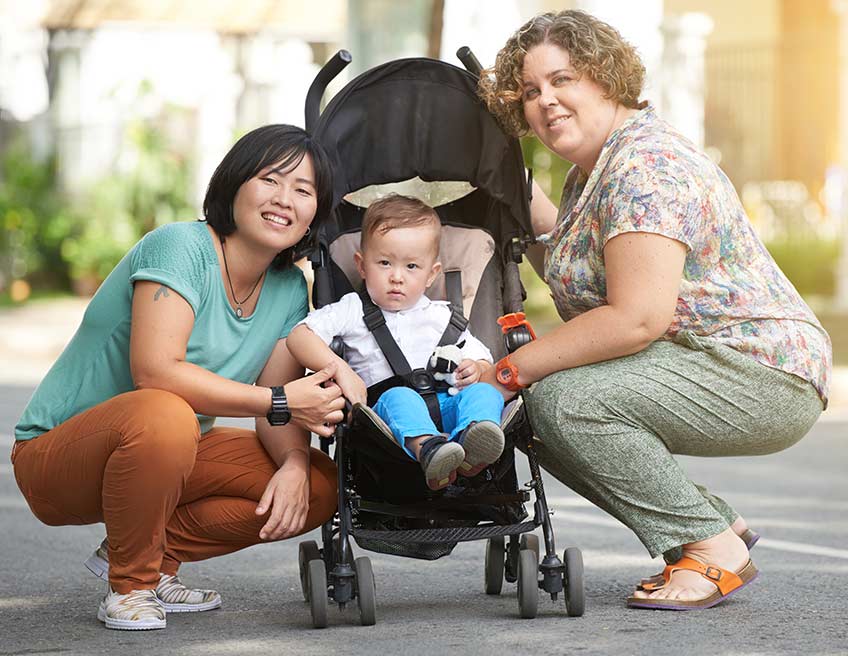 Smiling women with infant in stroller